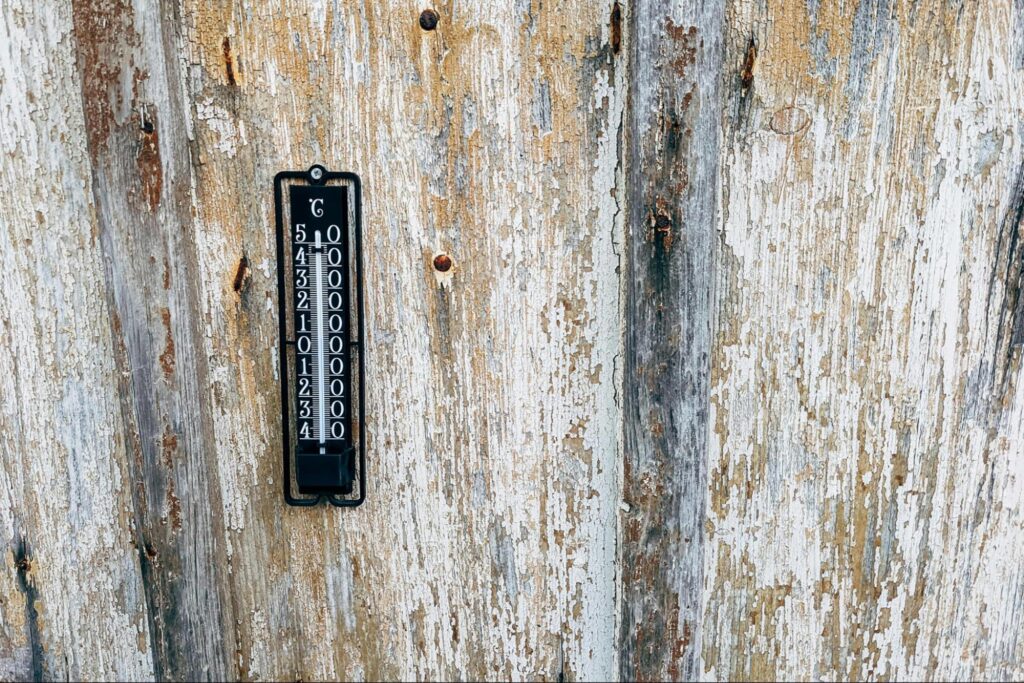 Thermometer in a run-down basement.