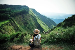 A woman enjoying mountain greenery, free of the burden of selling her house.