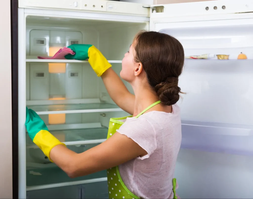 This woman shows how helpful it is to add cleaning out your refrigerator to your moving house checklist.