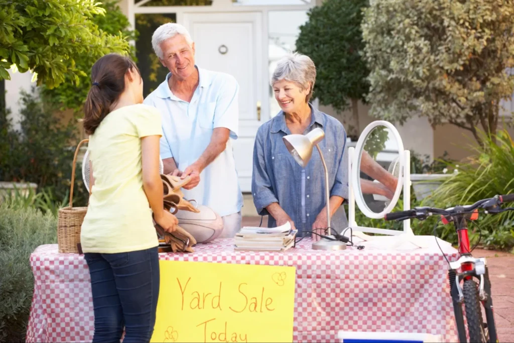 This couple is showing how to prepare for a move by having a yard sale.