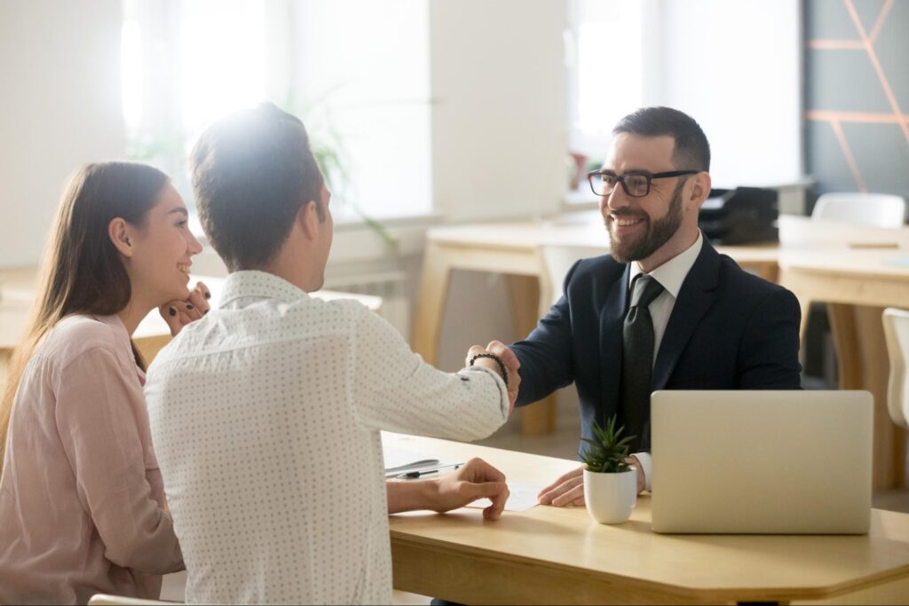 Home buyers meeting with a lender for mortgage pre-approval.
